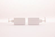 Simple and elegant white pump bottles on a clean white background, perfect for beauty product mockups.
